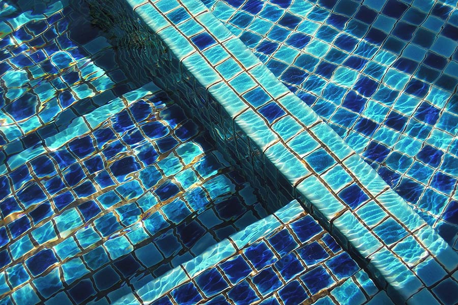 Photo of a pool with blue and cyan tiles